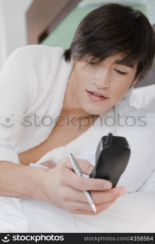 Young man holding a cordless phone