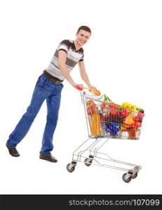 Young Man Holding a Full Shopping Trolley with Purchases of Daily Products isolated on White Background