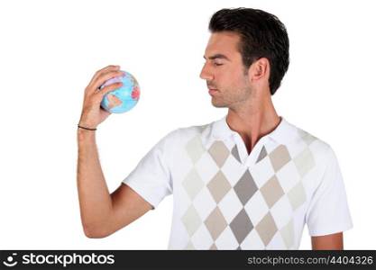 Young man holding a globe