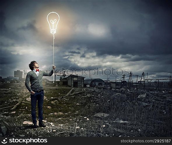 Young man holding a light