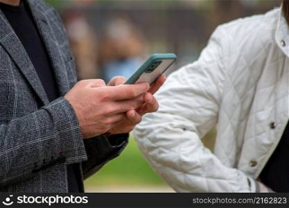 Young man holding a mobile phone. Looking at the phone.