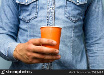 Young man holding a paper cup