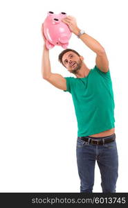 Young man holding a piggy-bank - money concept