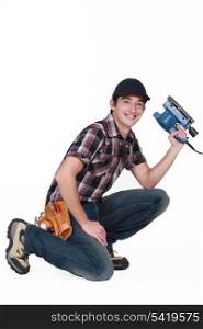 Young man holding a sander