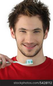 Young man holding a toothbrush