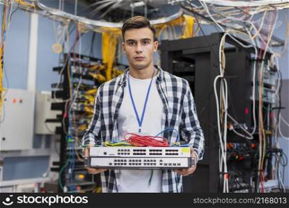 young man holding ethernet switches