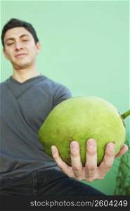 Young man holding fruit