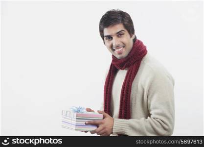 Young man holding gift box over white background