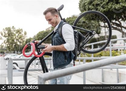 young man holding his bike