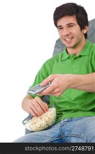 Young man holding remote control watch television and eat popcorn on white background, focus on hand