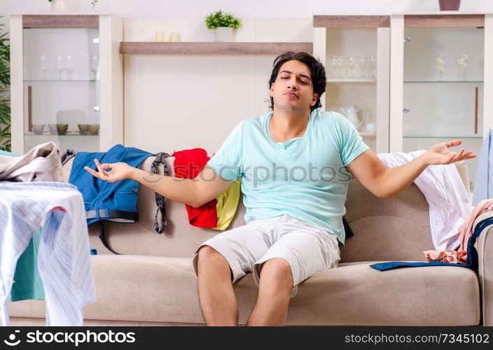 Young man husband ironing at home 