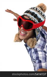 Young man in a snow hat and goggles
