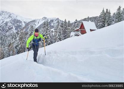 Young man in action on climbing touring skis