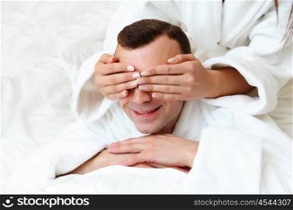 young man in bed with his eyes closed by woman