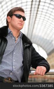 young man in black jacket and sunglasses