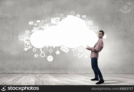 Young man in casual carrying cloud in hands. Man lifting cloud