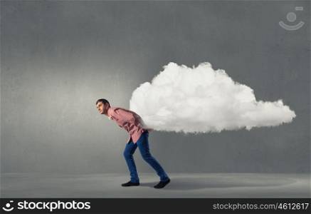 Young man in casual carrying cloud on back . Man lifting cloud