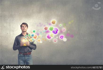 Young man in casual splashing icons from bucket