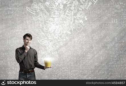 Young man in casual splashing paint from bucket