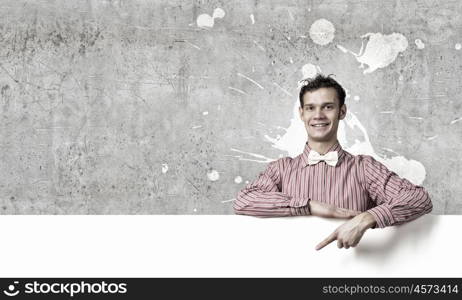 Young man in casual with white blank banner. Perfect place for your ad