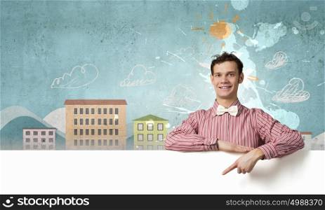 Young man in casual with white blank banner. Perfect place for your ad