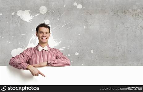 Young man in casual with white blank banner. Perfect place for your ad