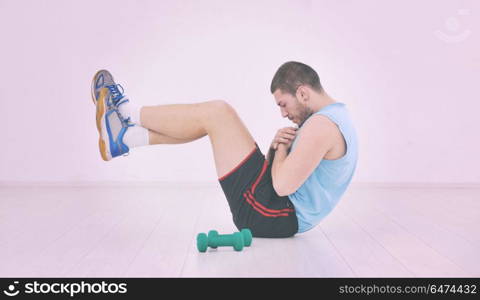 young man in fintess sport club exercise withweights and relaxing. man fitness workout