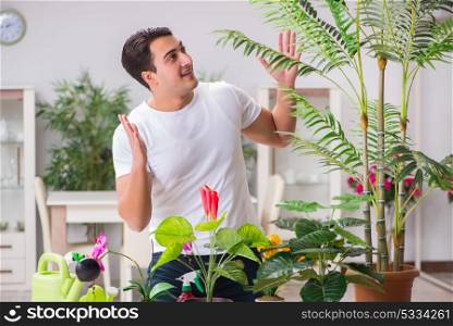 Young man in gardening concept at home