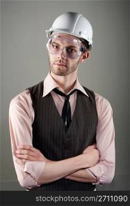 Young man in hard hat and safety goggles