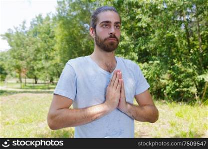 young man in meditation in forest