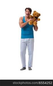 Young man in pajamas with toy animal isolated on white backgroun. Young man in pajamas with toy animal isolated on white background