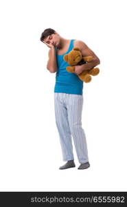 Young man in pajamas with toy animal isolated on white backgroun. Young man in pajamas with toy animal isolated on white background