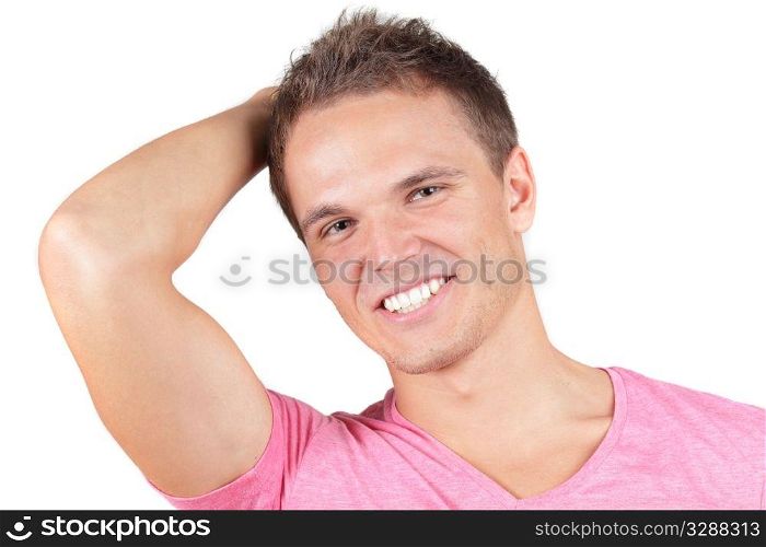 Young man in pink t-shirt smiling over white background