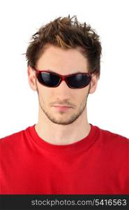 Young man in red rimmed sunglasses