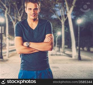 Young man in shirt outdoors at night