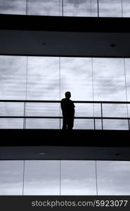 young man in silhouette in a modern office building