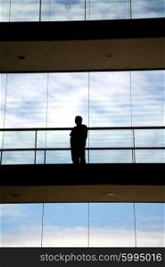 young man in silhouette in a modern office building