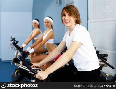 Young man in sport wear doing sport in gym