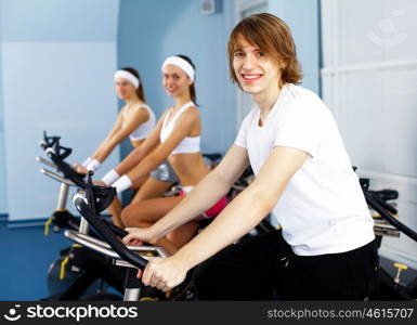 Young man in sport wear doing sport in gym