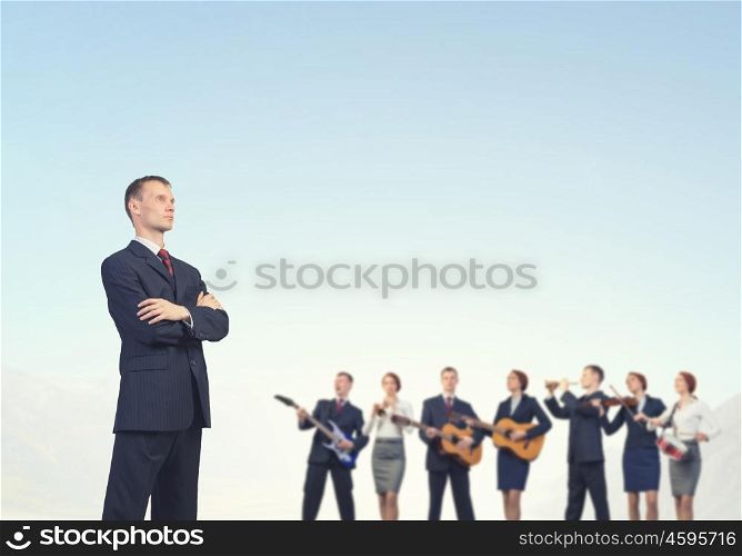 Young man in suit and people playing different music instruments. One man band