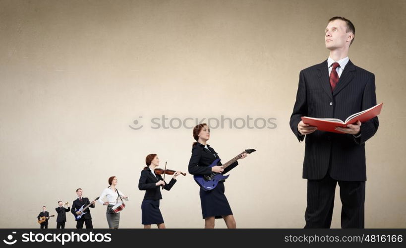 Young man in suit and people playing different music instruments. One man band