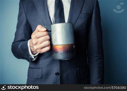 Young man in suit is holding a moka coffee pot