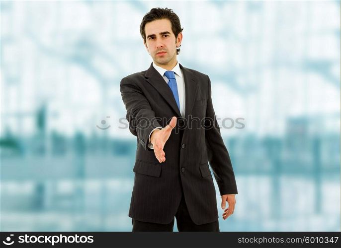 young man in suit offering to shake the hand