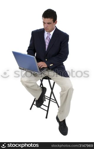 Young man in suit working on laptop.