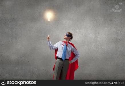 Young man in superhero costume representing creativity concept. Creativity is what I am god at