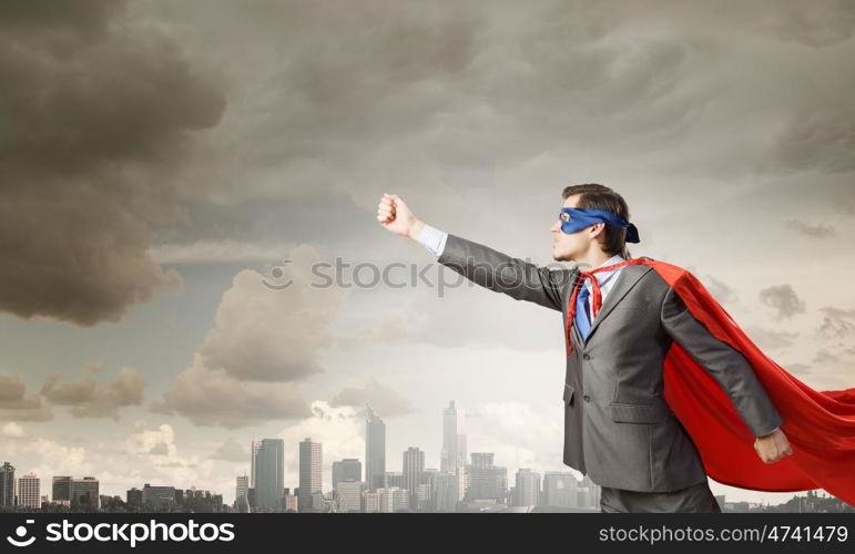 Young man in superhero costume representing power and courage