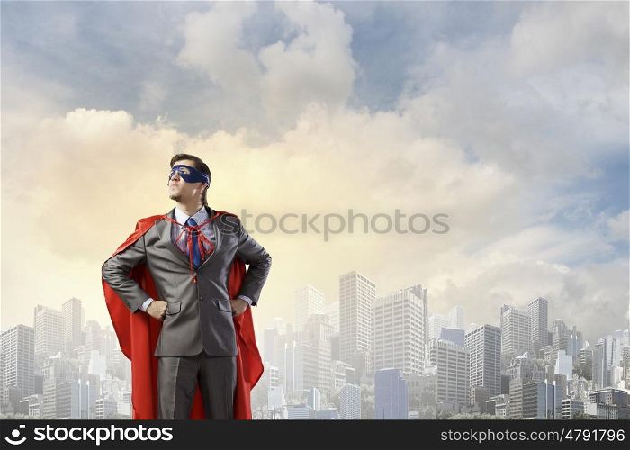 Young man in superhero costume representing power and courage
