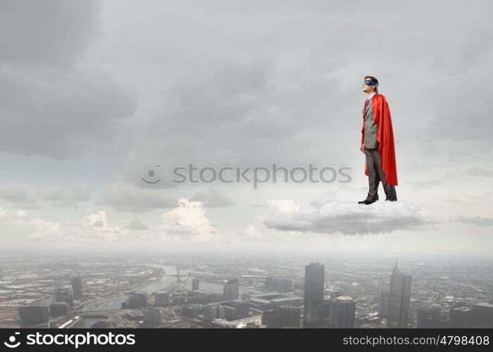 Young man in superhero costume representing power and courage