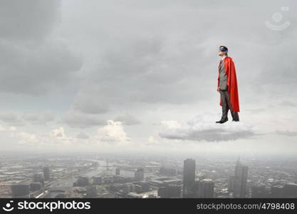 Young man in superhero costume representing power and courage