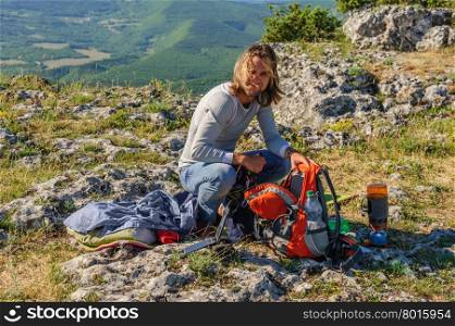 Young man in the morning light at the peak of mountain in Crimea, Ukraine